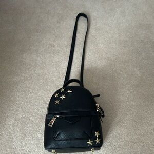 Black leather backpack with gold stars. Adjustable straps